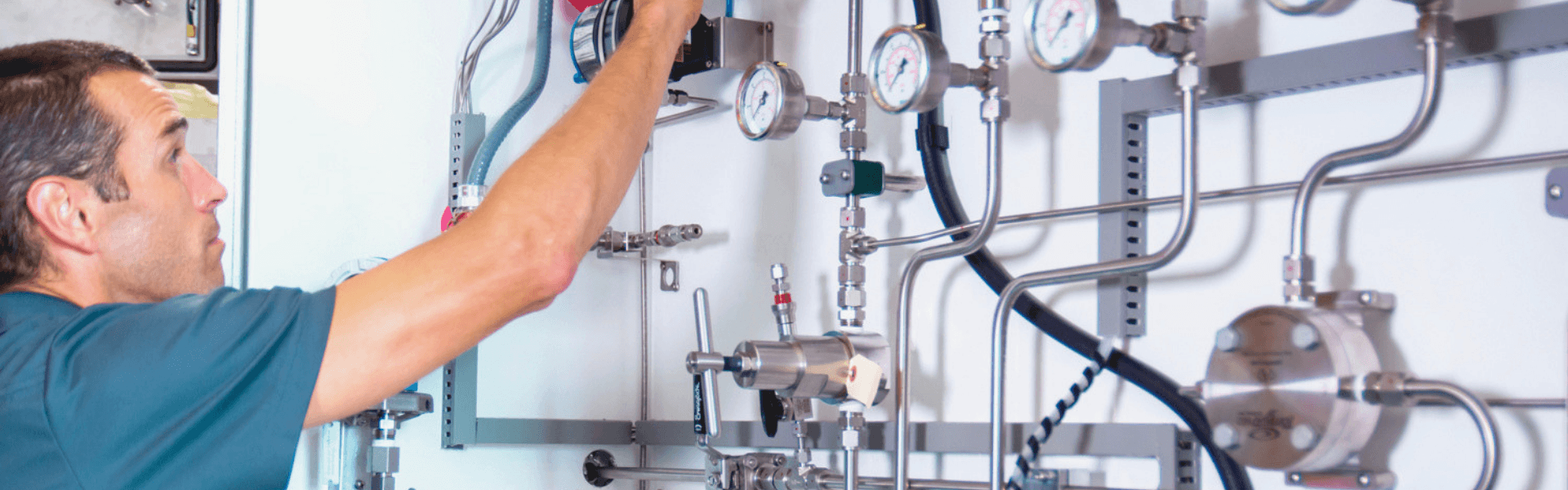 Engineer inspecting and adjusting a process analyzer sampling system during commissioning - Novatech